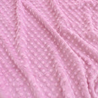 Silky minky dot fabric warm tones, folded bolt